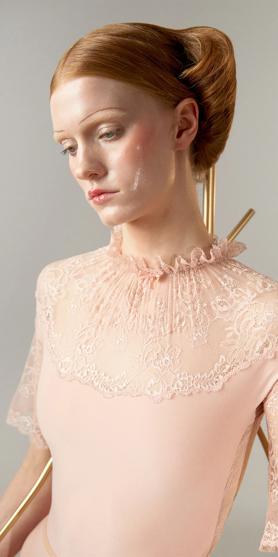 03_Mockneck-leotard-with-bell-sleeves-in-baby-pink-cropped-front-view-side-look.webp